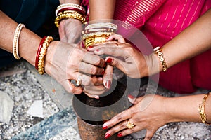 Group of women are performing Indian Bengali wedding rituals