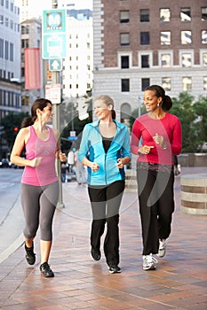 Group Of Women Power Walking On Urban Street