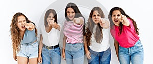 Group of women wearing casual clothes standing over isolated background pointing displeased and frustrated to the camera, angry