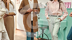 A group of women wearing fashionable clothes having a brainstorm and speaking to each other