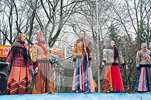 The group of women wearing traditional Russian clothers sing a song on Maslenitsa in Moscow.