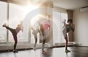 Group of women working out and fighting in gym