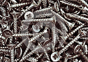 Group of wood  steel  screws , zinc heap chrome. Close up macro, dark industrial seamless background