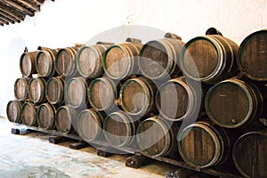 Group of wooden barrels from a wine cellar in spain. The barrels are full of wine from the last vintage. Concept wines of the