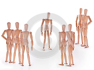 Group of wooden dummy characters standing around one