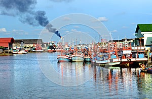 Group of wooden fishery boats stop at the estuary habour.