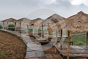 Group of wooden sheds with pathway in a rainy day at Khao Kor, P