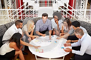 Group of work colleagues having meeting in an office lobby