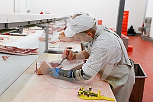 A group of worker in meat factory, chopped a fresh pork pieces on work, industry food