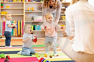 Group of workers with babies in nursery