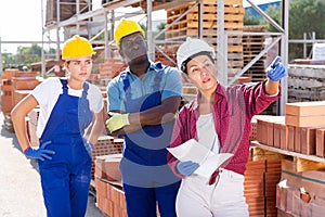 Group of workers discussing order list at warehouse