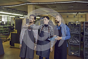 Group of workers giving the owner or inspector a tour around the shoe making factory