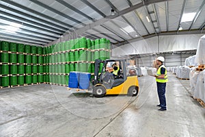 group of workers in the logistics industry work in a warehouse with chemicals