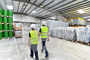 Group of workers in the logistics industry work in a warehouse w