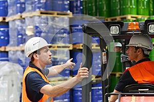 Group of workers in the logistics industry work in a warehouse w