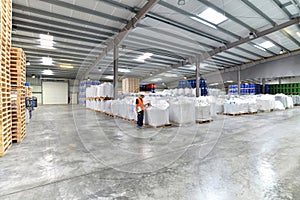 Group of workers in the logistics industry work in a warehouse w