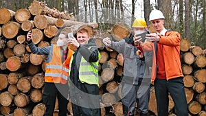 group workers takes selfie photo sawmill They holding telephones in their hands