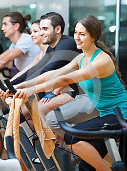 Group working out of cycling in fitness club