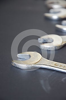 Group of wrenches arranged on dark background