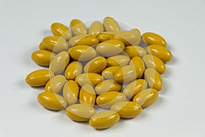 Group of yellow soft gelatine capsules.