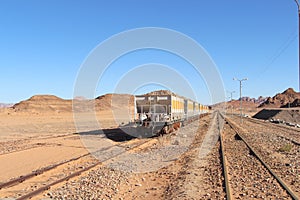 Group of yellow wagons with material for nitrogen fertilizers in desert