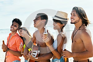 Group of young adults enjoys life at beach