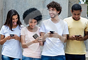 Group of young adults messsaging with mobile phones