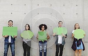 Group of young adults outdoors holding empty placard copyspace t