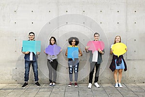 Group of young adults outdoors holding empty placard copyspace t