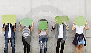 Group of young adults outdoors holding empty placard copyspace t