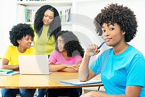 Group of young african american computer science students learning software development and programming