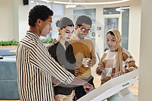 Group of young Arabian business professionals using digital screen in office