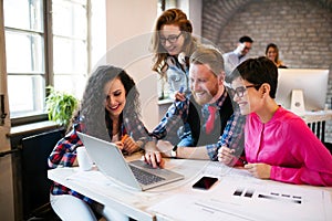 Group of young architects working on laptop