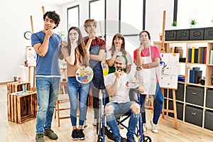 Group of young artists people at art studio serious face thinking about question with hand on chin, thoughtful about confusing