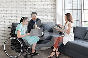 Group of young Asian disabled working woman with her colleagues, businessman and businesswoman working together