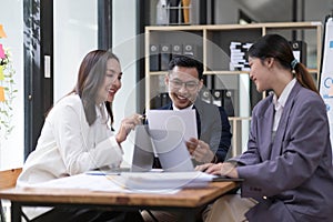 Group of young asian modern people in smart casual wear having a brainstorm meeting. Group of young asian business