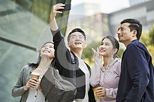 Group of young asian people talking a selfie together outdoors