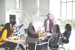 Group of young attractive asian creative design team meeting,smiling and laughing at office workshop. Asian employee engaged photo