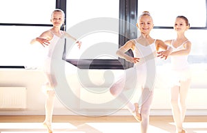 Group of young ballerinas practicing pirouettes