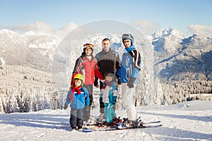 Group of young beautiful people, adults and kids, skiing