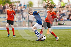 Group of young boys playing soccer game. Football match between youth soccer teams