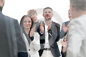 Group of young business people applauding together