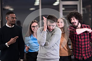 A group of young business people have fun playing interesting games while taking a break from work in a modern office