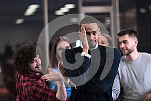 A group of young business people have fun playing interesting games while taking a break from work in a modern office