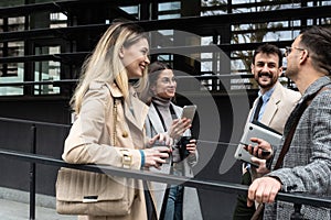 Group of young business people, job candidates standing in front of the office building waiting to be called to meeting with the