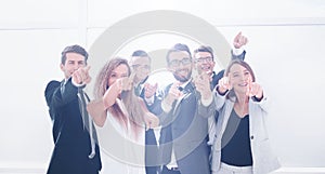 Group of young business people pointing at you