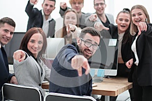 Group of young business people pointing at you