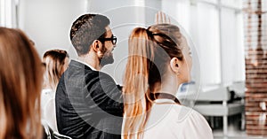 Group of young business people sitting in the conference room