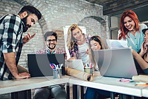 Group of young business people in smart casual wear working together