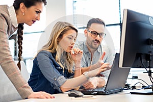 Group of business people and software developers working as a team in office photo